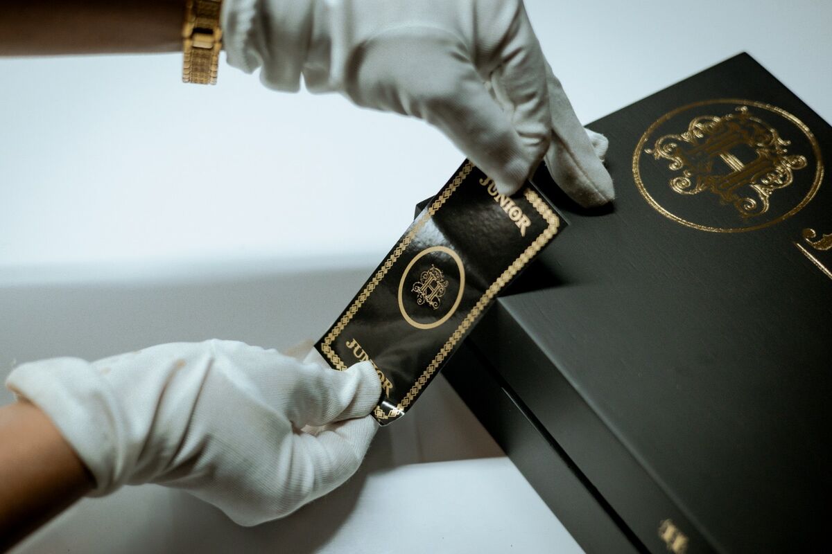 Gloved hands finishing an H Junior box